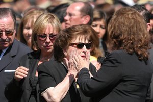 FILE - Lucia Hiriart de Pinochet, center, and her daughter Lucia are welcomed by a relative as they arrive to attend a mass during the funeral of her late husband, former dictator Gen. Augusto Pinochet at the Military Academy in Santiago, Dec. 12, 2006. Hiriart has died on Dec. 16, 2021