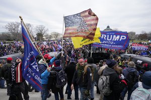 File - Insurrectionists loyal to President Donald Trump swarm the Capitol, Jan. 6, 2021, in Washington.