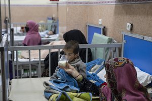 20 year-old Parwana gives milk to her two year-old son Mohammad as he undergoes treatment in the malnutrition ward of the Indira Gandhi Children's Hospital in Kabul, Afghanistan, on Wednesday, Dec. 8, 2021