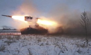 In this image taken from video and released by Russian Defense Ministry Press Service, A Russian rocket launcher fires during military drills near Orenburg in the Urals, Russia, Thursday, Dec. 16, 2021