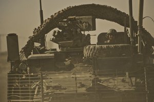 File - U.S. Army Command Sgt. Maj. Gary Mayo, 4th Battalion, 23rd Infantry Regiment, provides security while riding in a Stryker armored vehicle, Helmand province, Afghanistan, Jan. 15, 2010