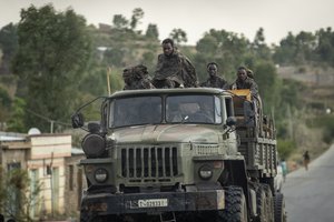 Ethiopian government soldiers ride in the back of a truck on a road leading to Abi Adi, in the Tigray region of northern Ethiopia on May 11, 2021