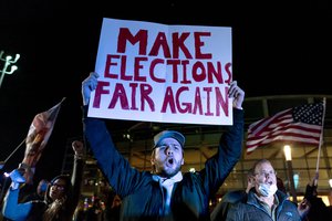 File - In this Nov. 5, 2020, file photo, Jake Contos, a supporter of President Donald Trump, chants during a protest against the election results outside the central counting board at the TCF Center in Detroit.