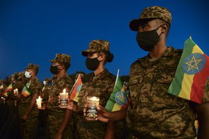 File - Current and former Ethiopian military personnel and the public commemorate federal soldiers killed by forces loyal to the Tigray People's Liberation Front (TPLF) at the start of the conflict one year ago, at a candlelit event outside the city administration in Addis Ababa, Ethiopia Wednesday, Nov. 3, 2021.