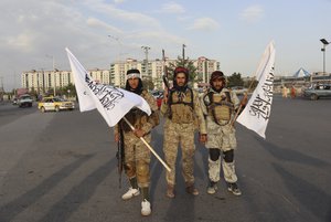 Taliban fighters hold Taliban flags in Kabul, Afghanistan, Monday, Aug. 30, 2021