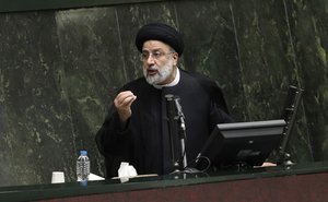 File - President Ebrahim Raisi defends his proposed ministers in a session of parliament, in Tehran, Iran, Wednesday, Aug. 25, 2021.