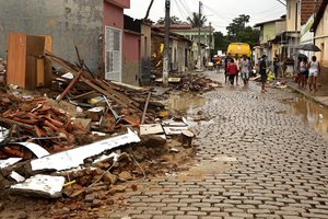 People work to salvage goods from homes destroyed by flooding in Itapetinga, Bahia state, Brazil, Monday, Dec. 27, 2021