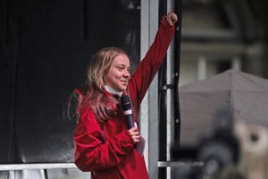 Swedish climate activist Greta Thunberg salutes after giving her speech on the stage of a demonstration in Glasgow, Scotland, Friday, Nov. 5, 2021 which is the host city of the COP26 U.N. Climate Summit.