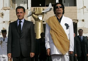 Libyan leader Moammar Gadhafi, right, and French President Nicolas Sarkozy during the National anthems at the Bab Azizia Palace in Tripoli