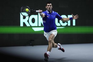 Serbia's Novak Djokovic returns the ball to Croatia's Marin Cilic during their Davis Cup tennis semi-final match at Madrid Arena in Madrid, Spain, Friday, Dec. 3, 2021