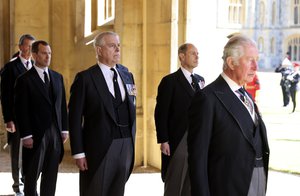 From right, Prince Charles, Prince Edward and Prince Andrew prepare to follow the procession during the funeral of Britain's Prince Philip inside Windsor Castle in Windsor, England, Saturday, April 17, 2021.