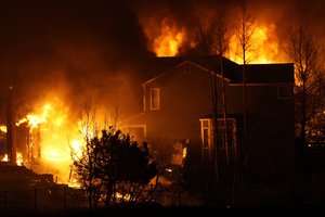 Homes burn as wildfires rip through a development Thursday, Dec. 30, 2021, in Superior, Colorado.