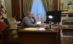 Russian President Vladimir Putin talks by phone to participants in the Wishing Christmas Tree charity campaign from Konstantin Palace in Strelna, outside in St. Petersburg, Russia, Monday, Dec. 27, 2021