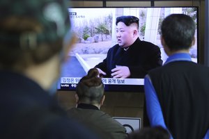 People watch a TV showing a file image of North Korean leader Kim Jong Un during a news program at the Seoul Railway Station in Seoul, South Korea