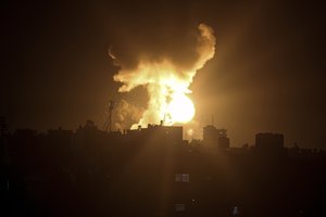 An explosion caused by Israeli airstrikes is seen in the town of Khan Younis, southern Gaza Strip, Sunday Jan, 2, 2022.