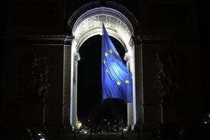 The European flag flies under the Arc de Triomphe to mark France's EU presidency in Paris, France, Saturday, Jan. 1, 2022.