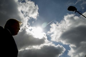 Donald Trump speaks to reporters about a shooting at a Pittsburgh synagogue at Indianapolis International Airport in Indianapolis