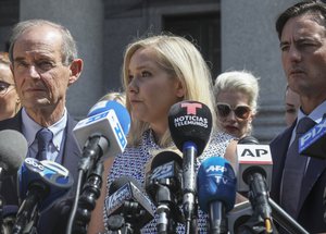 In this Aug. 27, 2019, photo, Virginia Roberts Giuffre, center, who says she was trafficked by sex offender Jeffrey Epstein, holds a news conference outside a Manhattan court where sexual assault claimants invited by a judge addressed a hearing following Epstein's jailhouse death in New York