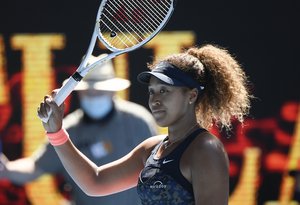 Japan's Naomi Osaka celebrates after defeating United States' Serena Williams in their semifinal match at the Australian Open tennis championship in Melbourne, Australia, Thursday, Feb. 18, 2021