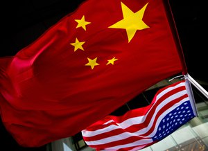 In this Nov. 7, 2012 photo, U.S. and Chinese national flags are hung outside a hotel during the U.S. Presidential election event, organized by the U.S. embassy in Beijing