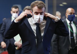 French President Emmanuel Macron arrives for an EU Summit at the European Council building in Brussels, Thursday, Dec. 16, 2021