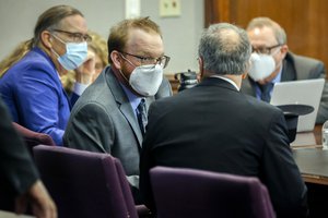 Travis McMichael, left, speaks with his attorney Bob Rubin, right, during the sentencing of his and his father Greg McMichael and neighbor, William "Roddie" Bryan, Friday, Jan. 7, 2022, in the Glynn County Courthouse in Brunswick, Ga. The three found guilty in the February 2020 slaying of 25-year-old Ahmaud Arbery