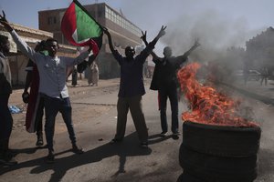 People chant slogans during a protest to denounce the October military coup, in Khartoum, Sudan, Thursday, Dec. 30, 2021