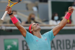 Spain's Rafael Nadal celebrates winning the semifinal match of the French Open tennis tournament against Argentina's Diego Schwartzman in three sets, 6-3, 6-3, 7-6, at the Roland Garros stadium in Paris, France, Friday, Oct. 9, 2020