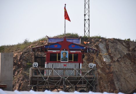 Wooden house structure with flag of china and Mao Zedong photo as sign of patriotism