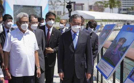 Sri Lankan president Gotabaya Rajapaksa, left, and Chinese foreign minister Wang Yi arrives at the Chinese funded sea reclamation Port City project in Colombo, Sri Lanka, Sunday, Jan. 9, 2022