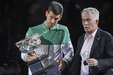 Serbia’s Novak Djokovic, left, stands with Australian Open tournament director Craig Tiley during the trophy presentation at the Australian Open tennis championships in Melbourne, Australia, Sunday, Feb 21, 2021