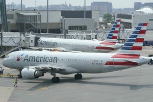 FILE - American Airlines passenger jets prepare for departure, Wednesday, July 21, 2021, near a terminal at Boston Logan International Airport, in Boston.