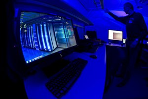 This Friday Jan. 11, 2013 file photo of a member of the Cybercrime Center as he turns on the light in a lab during a media tour at the occasion of the official opening of the Cybercrime Center at Europol headquarters in The Hague, Netherlands.