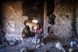 File - Sudanese girls sit inside an abandoned army outpost near Ieropigi village, northern Greece, at the Greek - Albanian border, on Saturday, Sept. 25, 2021.