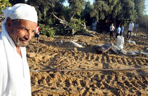 File - Palestinians inspect the damage following Israeli army raids on a refugee camp in the West Bank.