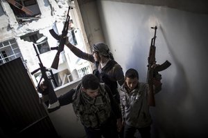 File - Free Syrian Army members react to fighting in Aleppo, Syria, Thursday, Jan. 3, 2013. The area is immersed in a Syrian civil war that the United Nations estimates has killed more than 60,000 people since the revolt against President Bashar Assad began in March 2011.