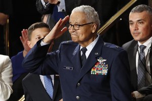 Tuskegee airman Charles McGee, 100, salutes as his great grandson Iain Lanphier