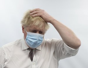 Britain's Prime Minister Boris Johnson gestures during a visit to Finchley Memorial Hospital, in North London, Tuesday, Jan. 18, 2022.