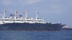 In this March 7, 2021, photo provided by the Philippine Coast Guard/National Task Force-West Philippine Sea, some of the 220 Chinese vessels are seen moored at Whitsun Reef, South China Sea.