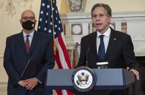 Secretary of State Antony Blinken speaks in the Benjamin Franklin Room of the State Department in Washington, Friday, Nov. 5, 2021, as Jonathan Moore listens.