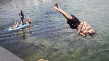 Swimmers enjoy the warm weather at Narrabeen Lakes on Sydney’s northern beaches on Sunday.