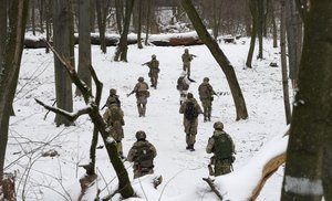 Members of Ukraine's Territorial Defense Forces, volunteer military units of the Armed Forces, train in a city park in Kyiv, Ukraine, Saturday, Jan. 22, 2022. Dozens of civilians have been joining Ukraine's army reserves in recent weeks amid fears about Russian invasion.