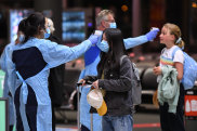 Passengers arrive from a Qantas flight that flew from Melbourne at Sydney Airport to be met by health officials taking their temperature on July 06, 2020 in Sydney, Australia. The NSW-Victoria border will close at 11.59pm on Tuesday evening due to a large spike in COVID-19 cases in Victoria. Victoria has recorded 127 new cases within a 24-hour reporting period, the state’s highest ever daily case increase. (Photo by James D. Morgan/Getty Images) Getty image for Traveller. Single use only.