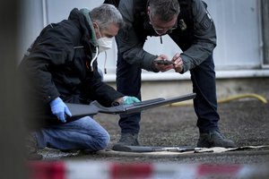 Police officers secure traces on the grounds of the Heidelberg University Botanical Garden in Heidelberg, Germany, Monday, Jan. 24, 2022