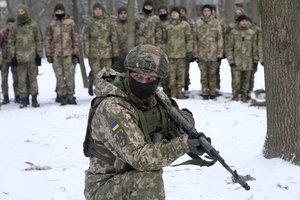 An instructor trains members of Ukraine's Territorial Defense Forces, volunteer military units of the Armed Forces, in a city park in Kyiv, Ukraine, Saturday, Jan. 22, 2022.