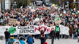 Participants at a Fridays for Future demonstration hold a banner with the inscription "Climate Justice Now" in Munich, Germany, on November 29, 2019. 