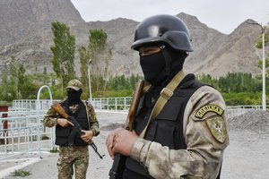 Two Kyrgyz soldiers guard a water supply facility outside the village of Kok-Tash near Kyrgyzstan-Tajikistan border in southwestern Kyrgyzstan, about 440 kilometers (275 miles) south-west of Bishkek, Kyrgyzstan, Wednesday, May 5, 2021