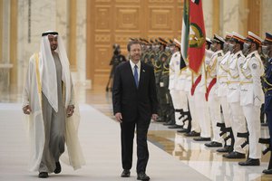 President Isaac Herzog, walks with the Crown Prince of Abu Dhabi, Sheikh Mohammed bin Zayed Al Nahyan, left, as they review an honor guard, at the royal palace, in Abu Dhabi, United Arab Emirates, Sunday, Jan. 30, 2022