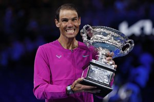 Rafael Nadal of Spain holds the Norman Brookes Challenge Cup after defeating Daniil Medvedev of Russia in the men's singles final at the Australian Open tennis championships in Melbourne, Australia, early Monday, Jan. 31, 2022