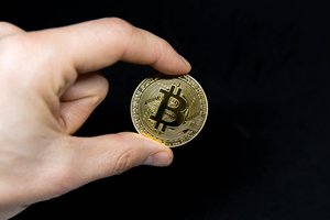 Bitcoin coin in front of black background